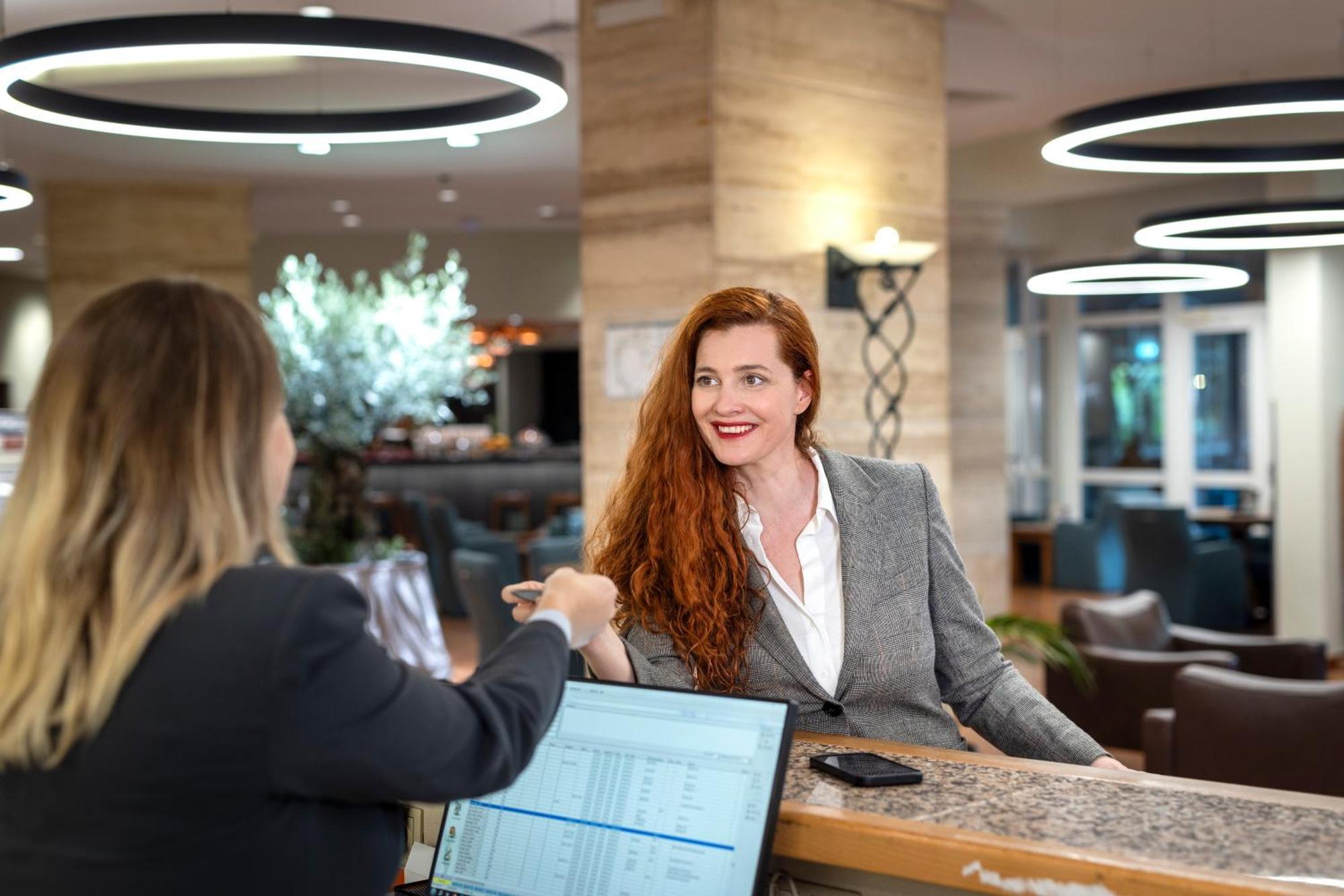 Rogner Hotel Tirana Exterior photo A hotel receptionist