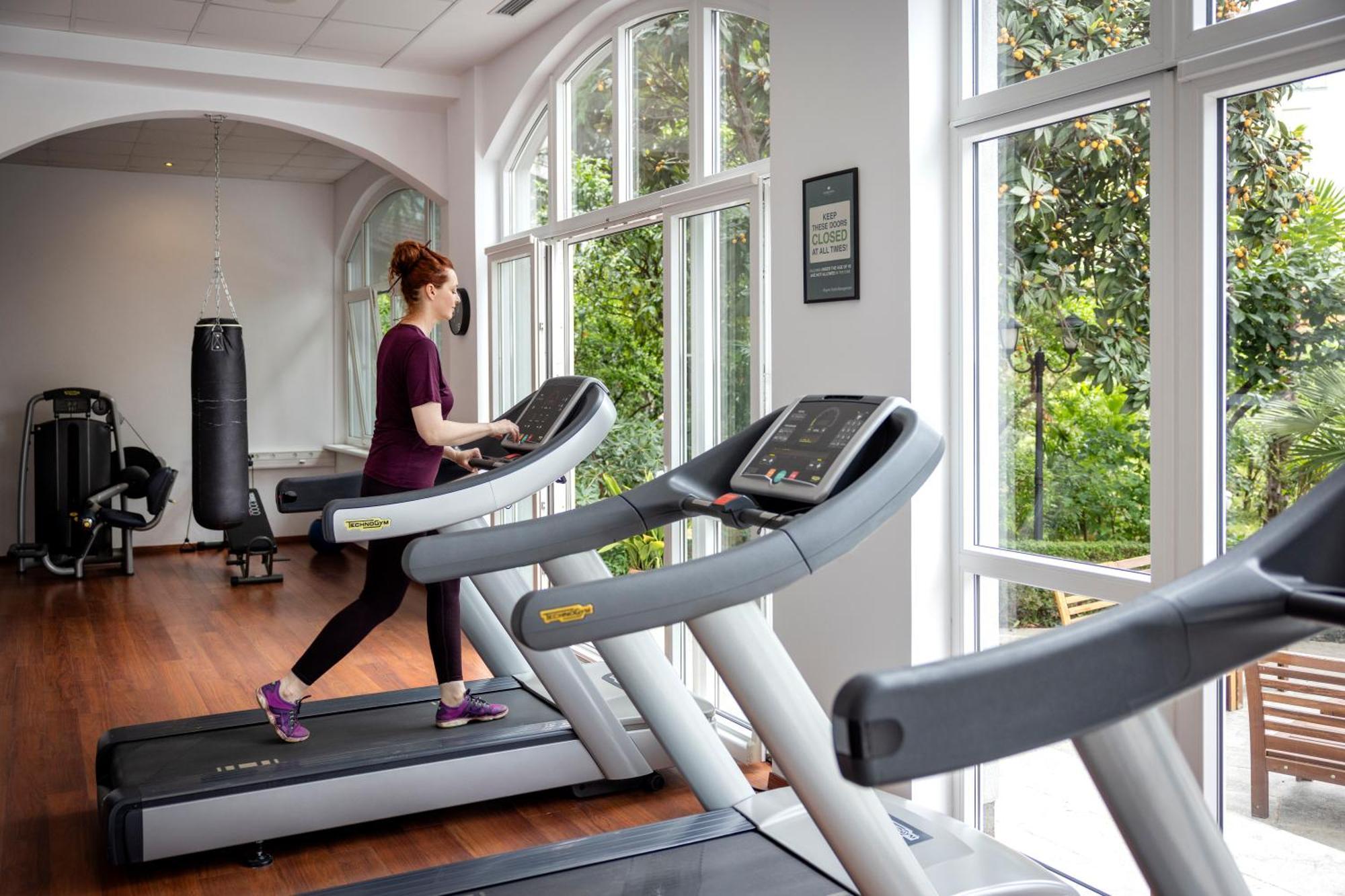 Rogner Hotel Tirana Exterior photo A woman on a treadmill